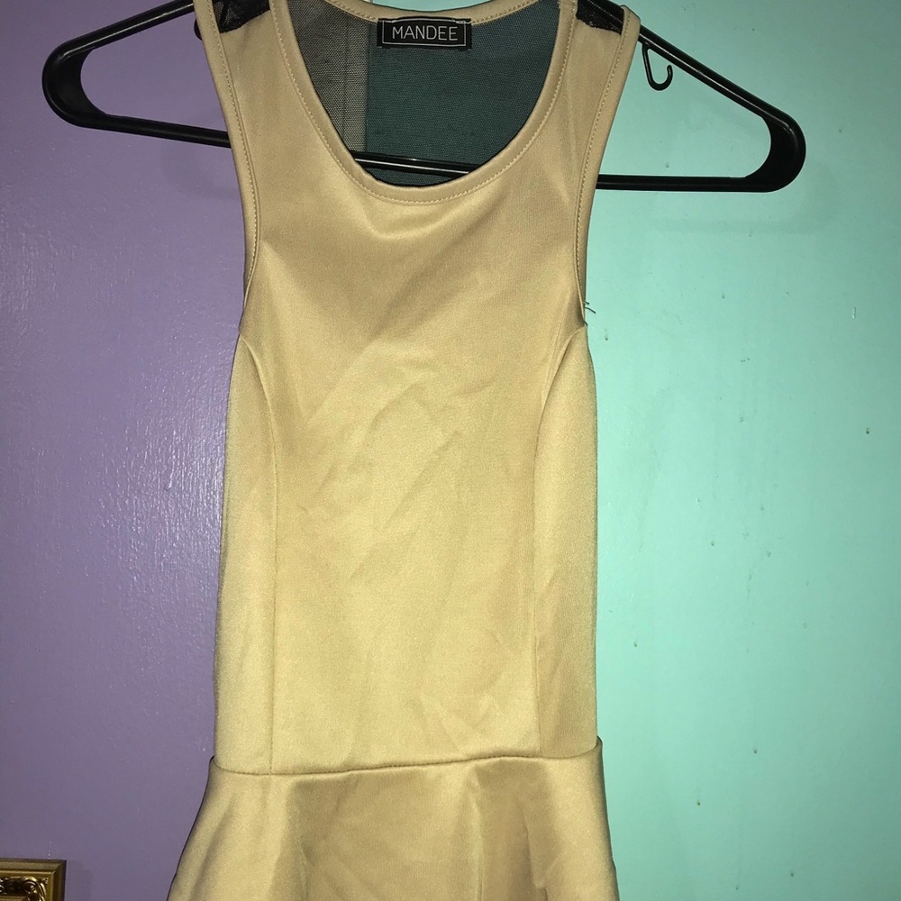 A beige peplum top with net back